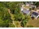 An aerial view shows a property backing onto a green area with solar panels visible on a neighboring house at 304 Nelson Ln, Clayton, NC 27527