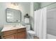 Bathroom features a shower, vanity and toilet with neutral wall color at 304 Nelson Ln, Clayton, NC 27527