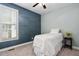 Cozy bedroom with wainscoting, plush carpet, ceiling fan, and a bright window at 304 Nelson Ln, Clayton, NC 27527
