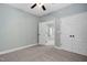 Spacious bedroom with plush carpet, neutral paint, ceiling fan, and dual closets at 304 Nelson Ln, Clayton, NC 27527
