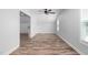Bonus room with lots of natural light has a ceiling fan and luxury vinyl flooring at 304 Nelson Ln, Clayton, NC 27527