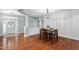 Elegant dining room boasting a stylish chandelier, herringbone accent wall, and hardwood floors at 304 Nelson Ln, Clayton, NC 27527