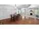 Open dining area with decorative chandelier, leading to living room with fireplace and kitchen access at 304 Nelson Ln, Clayton, NC 27527