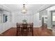 Dining area showcasing a beaded chandelier, accent wall, and adjacent views to the kitchen at 304 Nelson Ln, Clayton, NC 27527