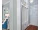 Mud room features a white storage bench, hardwood floors, and neutral paint at 304 Nelson Ln, Clayton, NC 27527
