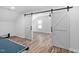 Large game room features rustic sliding barn doors that open to a bright living space at 304 Nelson Ln, Clayton, NC 27527