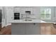 Modern kitchen with marble countertops, a center island and stainless steel appliances at 304 Nelson Ln, Clayton, NC 27527