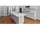 Stylish kitchen equipped with a center island, stainless steel appliances, and mosaic backsplash at 304 Nelson Ln, Clayton, NC 27527