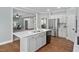 Open kitchen featuring stainless steel appliances, a center island, and hardwood flooring at 304 Nelson Ln, Clayton, NC 27527