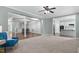 Open-concept living room with decorative columns, views to other rooms and neutral colored walls at 304 Nelson Ln, Clayton, NC 27527