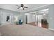 Spacious living room with a blue chair, decorative columns and entry ways to other rooms at 304 Nelson Ln, Clayton, NC 27527