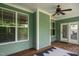 Charming covered patio with wooden floors and stylish decor provides a perfect outdoor retreat at 304 Nelson Ln, Clayton, NC 27527