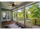 Inviting porch featuring wooden floors, white railings, and scenic views of the lush, green trees at 304 Nelson Ln, Clayton, NC 27527