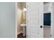Charming powder room featuring pedestal sink, decorative wallpaper, and hardwood floors at 304 Nelson Ln, Clayton, NC 27527