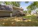 Back of house features a spacious deck, outdoor access and serene backyard at 3113 Chelmshire Ct, Raleigh, NC 27610