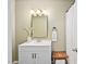 Stylish bathroom vanity featuring a modern mirror, unique lighting, and a comfortable stool at 3113 Chelmshire Ct, Raleigh, NC 27610