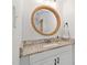 Elegant bathroom with a round mirror, granite countertop, white vanity and a modern faucet at 3113 Chelmshire Ct, Raleigh, NC 27610