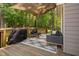 Charming deck with a shaded seating area and view of the landscaped backyard at 3113 Chelmshire Ct, Raleigh, NC 27610