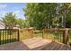 Wooden deck overlooking a lush backyard with mature trees at 3113 Chelmshire Ct, Raleigh, NC 27610