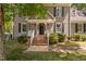 A welcoming front entrance with brick steps, white railings, and a black front door at 3113 Chelmshire Ct, Raleigh, NC 27610