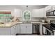Modern kitchen featuring granite countertops, stainless steel appliances, and a view of the backyard at 3113 Chelmshire Ct, Raleigh, NC 27610
