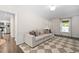 A comfortable living area with a couch, hardwood floors, and a neutral color palette at 3113 Chelmshire Ct, Raleigh, NC 27610