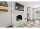 Cozy living room with a fireplace, hardwood floors, and modern decor at 3113 Chelmshire Ct, Raleigh, NC 27610