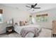 Bright main bedroom features a ceiling fan, a neutral color palette, windows with woven blinds, and a patterned rug at 3113 Chelmshire Ct, Raleigh, NC 27610