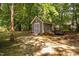 Backyard shed with double doors for storage, landscaping equipment, or a hobby space at 3113 Chelmshire Ct, Raleigh, NC 27610