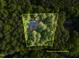 An aerial view showing property lines around a house surrounded by a green canopy of trees at 327 Woodbridge Dr, Chapel Hill, NC 27516