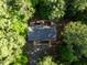 Aerial view of a gray roofed house surrounded by a lush green tree canopy at 327 Woodbridge Dr, Chapel Hill, NC 27516