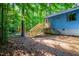 Side view of the house featuring stairs to the deck, and wooded backyard at 327 Woodbridge Dr, Chapel Hill, NC 27516