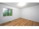 Bright bedroom with light wood floors and a window overlooking the greenery at 327 Woodbridge Dr, Chapel Hill, NC 27516