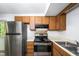 Functional kitchen with stainless steel appliances and wood cabinetry at 327 Woodbridge Dr, Chapel Hill, NC 27516