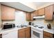 Functional kitchen with white appliances and wooden cabinets at 327 Woodbridge Dr, Chapel Hill, NC 27516