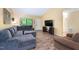 Inviting living room featuring a large sofa, oversized window, and wood floors at 327 Woodbridge Dr, Chapel Hill, NC 27516