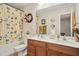Bathroom with double vanity sinks, a shower-tub combo, and a floral shower curtain at 3633 Willow Stone Ln, Wake Forest, NC 27587