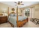 Spacious bedroom with a four-poster bed, window views, and bedside tables at 3633 Willow Stone Ln, Wake Forest, NC 27587