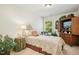 Cozy bedroom with a decorative bed frame and a window offering natural light at 3633 Willow Stone Ln, Wake Forest, NC 27587