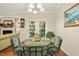 Cozy breakfast nook with a glass table, chandelier, and doors leading to the backyard at 3633 Willow Stone Ln, Wake Forest, NC 27587