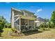 Home's exterior featuring a screened porch, patio, and meticulously landscaped backyard at 3633 Willow Stone Ln, Wake Forest, NC 27587