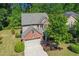 Aerial view of a two-story brick home with a two-car garage and mature trees at 3633 Willow Stone Ln, Wake Forest, NC 27587