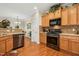 Well-equipped kitchen with stainless steel appliances, granite countertops, and wooden cabinets at 3633 Willow Stone Ln, Wake Forest, NC 27587
