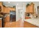Bright kitchen featuring stainless steel appliances, granite countertops, and hardwood floors at 3633 Willow Stone Ln, Wake Forest, NC 27587