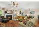 Cozy living room with fireplace, plush seating, and view of dining area through French doors at 3633 Willow Stone Ln, Wake Forest, NC 27587