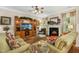 Comfortable living room with fireplace and entertainment center, featuring plush sofas and stylish decor at 3633 Willow Stone Ln, Wake Forest, NC 27587
