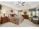 Serene primary bedroom featuring a tray ceiling, comfortable bed, and matching wooden dressers at 3633 Willow Stone Ln, Wake Forest, NC 27587