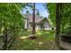 View of the back of the home with a screened porch and fire pit area at 3650 Brooks Bnd, Franklinton, NC 27525