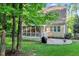 Backyard with patio, screened-in porch, and lush greenery offers ideal outdoor entertaining and relaxation at 3650 Brooks Bnd, Franklinton, NC 27525