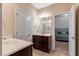 Well-lit bathroom with double sinks and a view into the bedroom with a bed at 3650 Brooks Bnd, Franklinton, NC 27525